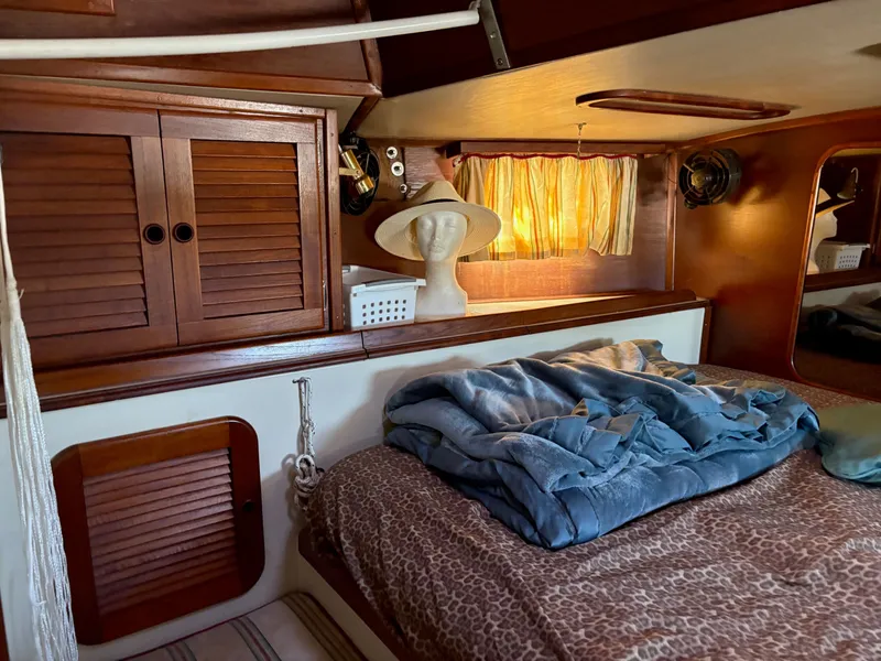 Slide: The Image of Cozy cabin interior of 1984 Irwin 41 sailboat with wooden cabinets and bed. - 25