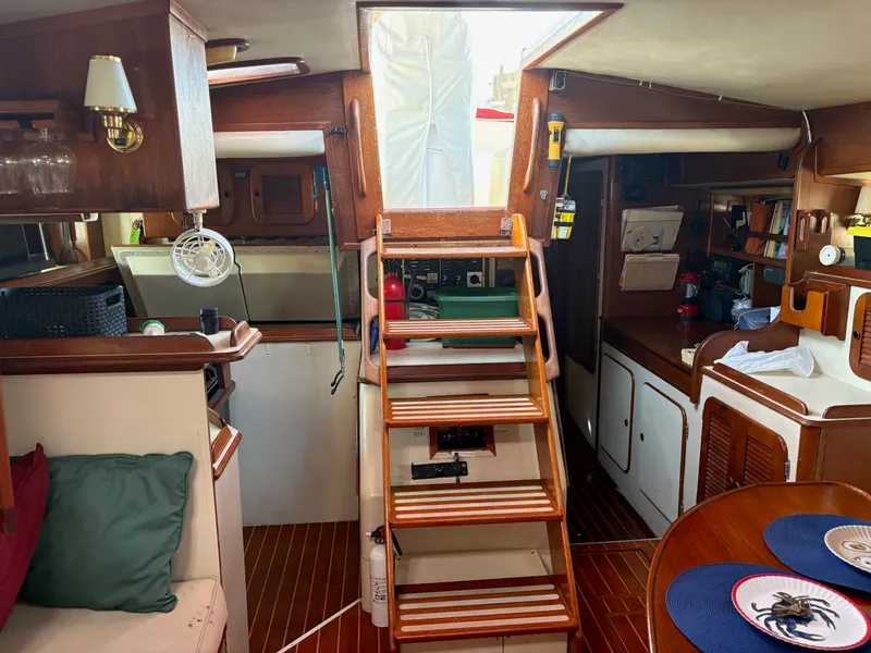 Slide: The Image of Interior of 1984 Irwin 41 sailboat with wooden stairs and cozy seating area. - 29