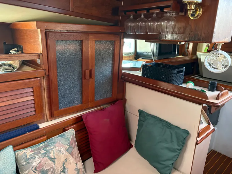 Slide: The Image of Cozy interior of 1984 Irwin 41 sailboat with wooden cabinets and colorful cushions. - 32
