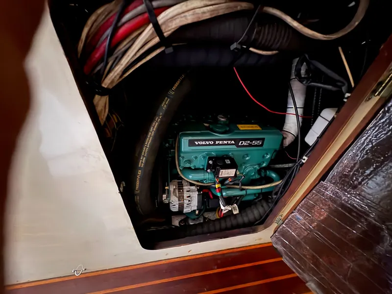 Slide: The Image of Volvo Penta D2-55 engine in 1984 Irwin 41 sailboat, surrounded by cables and hoses. - 34