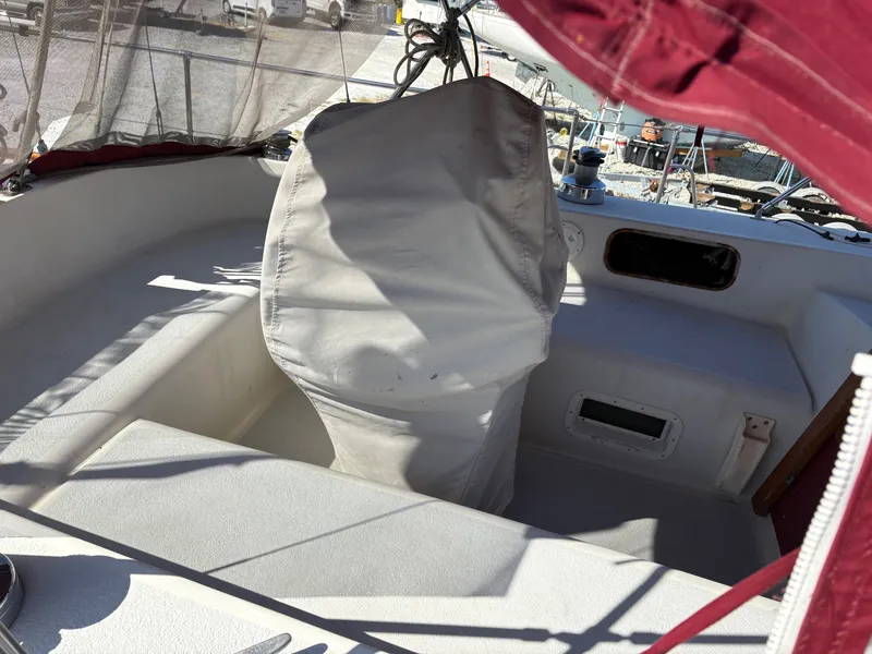 Slide: The Image of Cockpit of 1984 Irwin 41 sailboat with covered steering wheel and red canopy. - 4