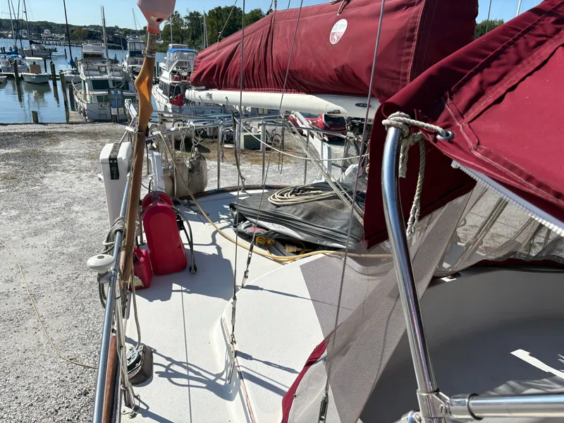 Slide: The Image of 1984 Irwin 41 sailboat with red canvas, docked at a marina. - 5