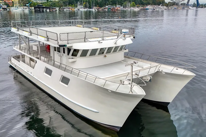 The Image of 2007 MetalCraft 92' Catamaran on calm water, featuring spacious deck and modern design. - 0