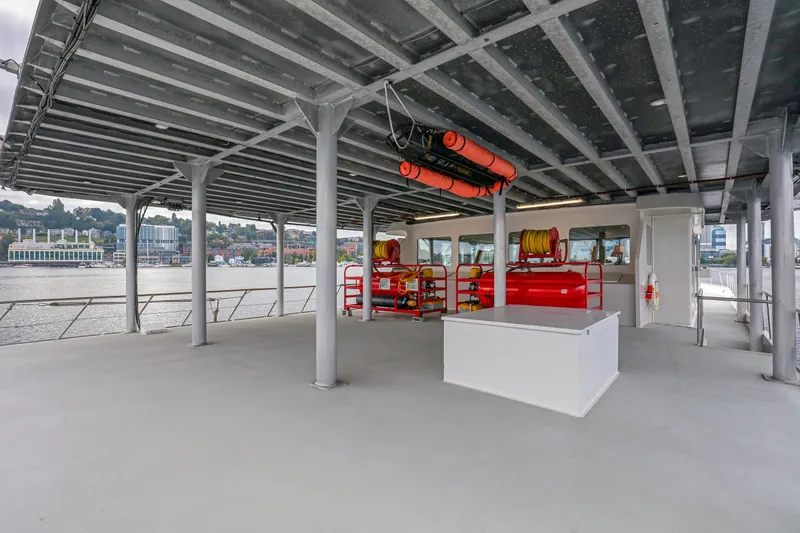 Slide: The Image of Spacious deck of 2007 MetalCraft Catamaran with safety equipment and waterfront view. - 10