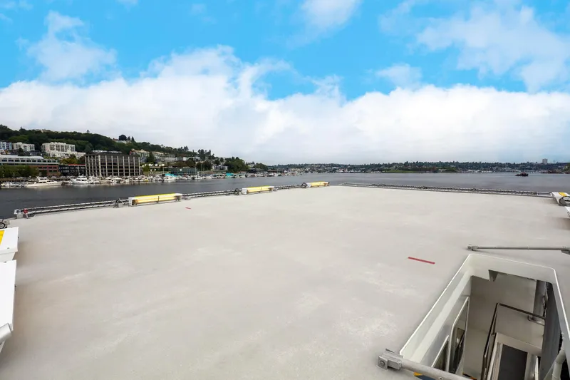 Slide: The Image of 2007 MetalCraft Catamaran deck with waterfront view and cityscape in the background. - 12