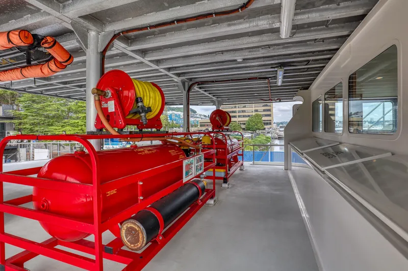 Slide: The Image of 2007 MetalCraft Catamaran deck with fire safety equipment and hose reels. - 16