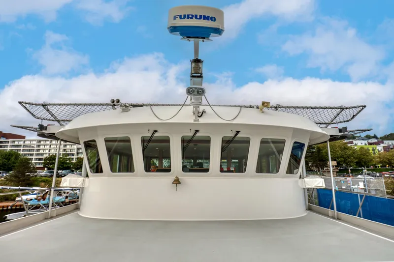 Slide: The Image of 2007 MetalCraft Catamaran with Furuno radar, docked in a marina under a blue sky. - 19