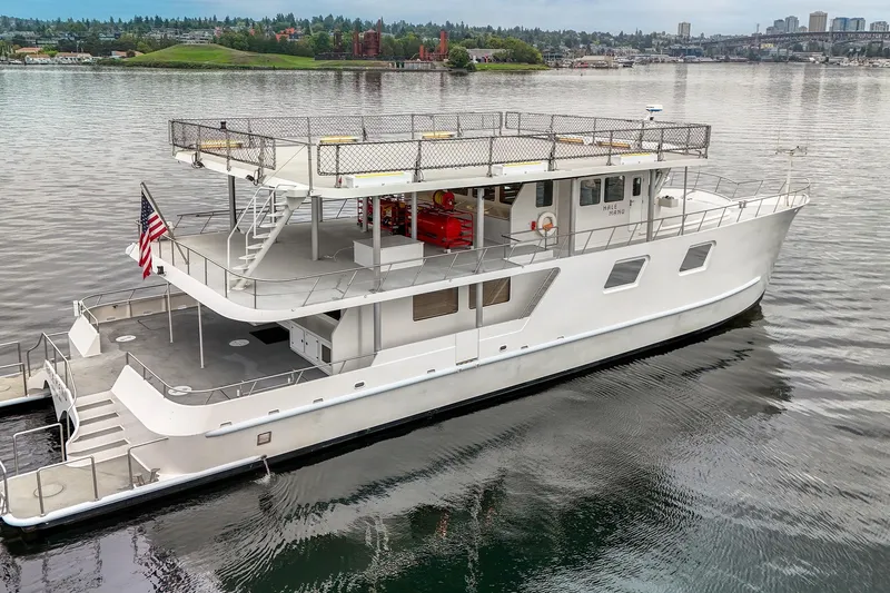 Slide: The Image of 2007 MetalCraft Catamaran on calm water, featuring spacious decks and modern design. - 2