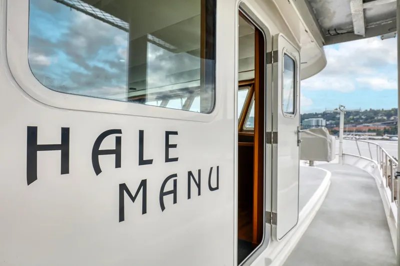 Slide: The Image of 2007 MetalCraft Catamaran "Hale Manu" with open cabin door, docked by waterfront. - 20
