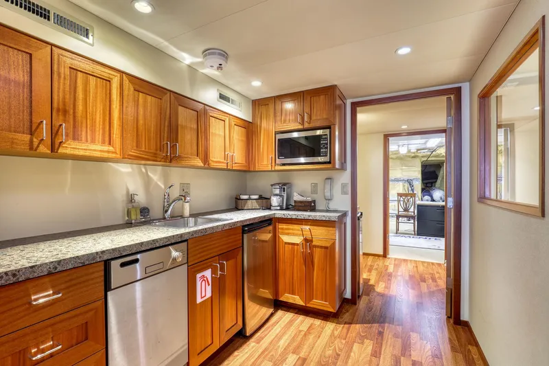 Slide: The Image of Luxurious 2007 MetalCraft Catamaran kitchen with wooden cabinets and modern appliances. - 25