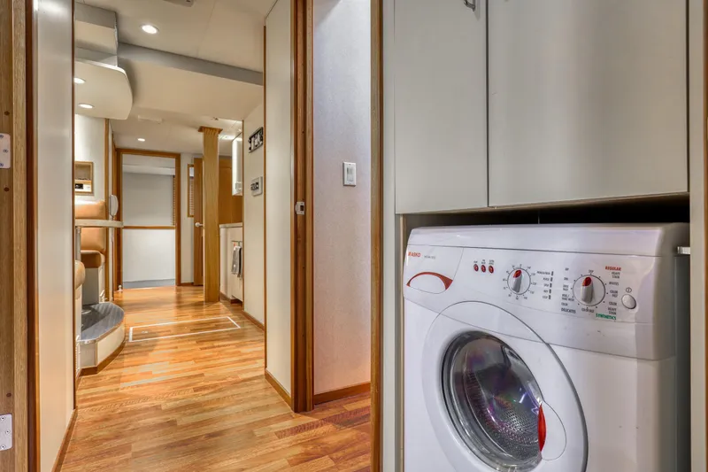 Slide: The Image of Interior of 2007 MetalCraft Catamaran with wood flooring and washing machine. - 27