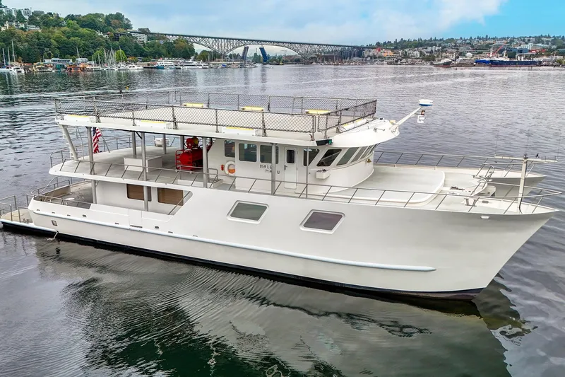 Slide: The Image of 2007 MetalCraft Catamaran on calm water, with bridge and shoreline in background. - 3
