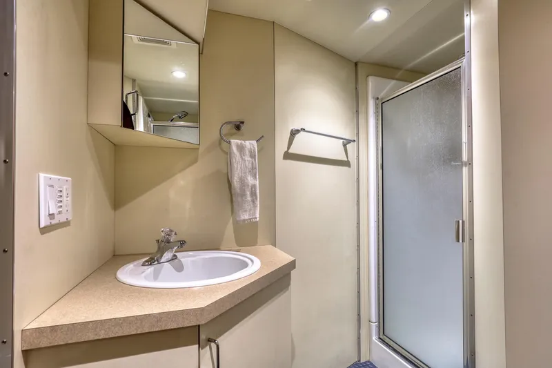 Slide: The Image of Modern bathroom in 2007 MetalCraft Catamaran with sink, mirror, and shower. - 33