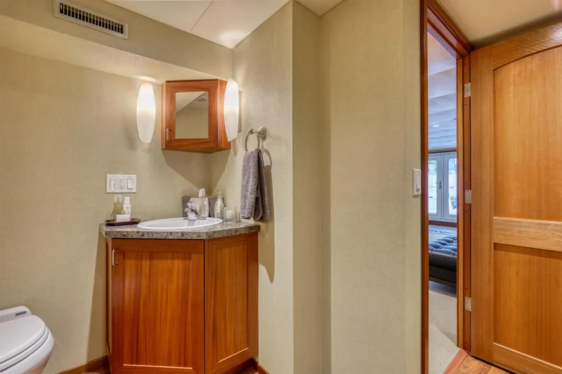 Slide: The Image of Luxurious 2007 MetalCraft Catamaran bathroom with wooden cabinetry and modern fixtures. - 34