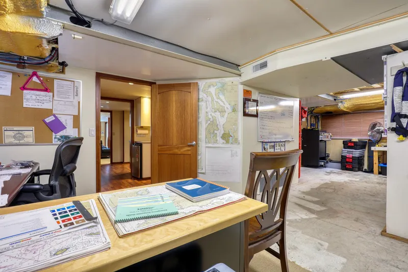 Slide: The Image of Office space inside a 2007 MetalCraft Catamaran, featuring maps, desk, and chair. - 35