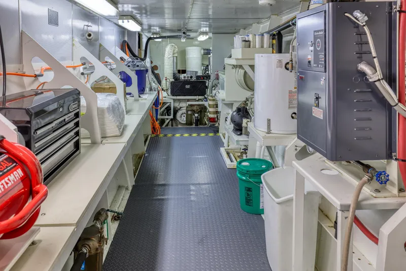 Slide: The Image of Engine room of a 2007 MetalCraft Catamaran, featuring tools and machinery. - 39