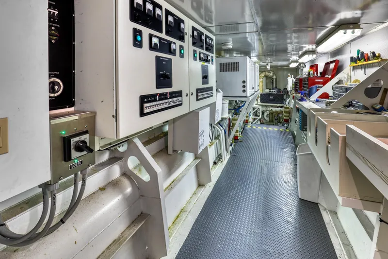 Slide: The Image of Engine room of a 2007 MetalCraft Catamaran with control panels and tools. - 44