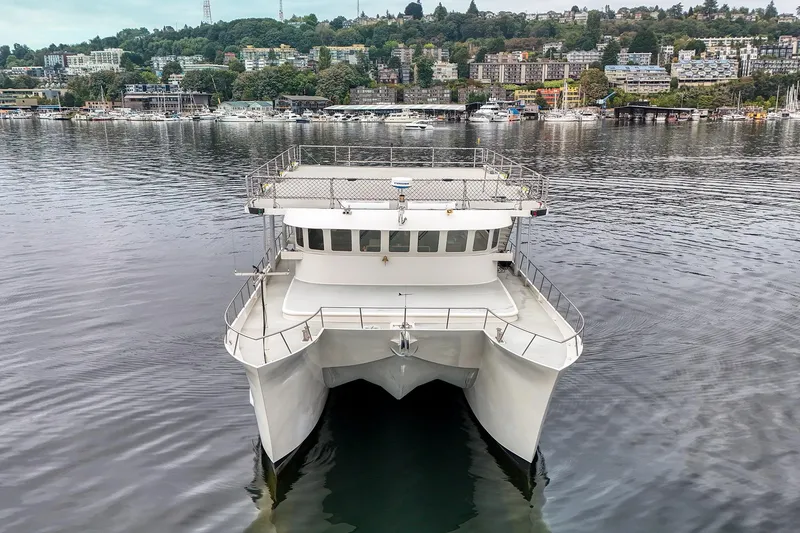 Slide: The Image of 2007 MetalCraft Catamaran on calm water with scenic city backdrop. - 5