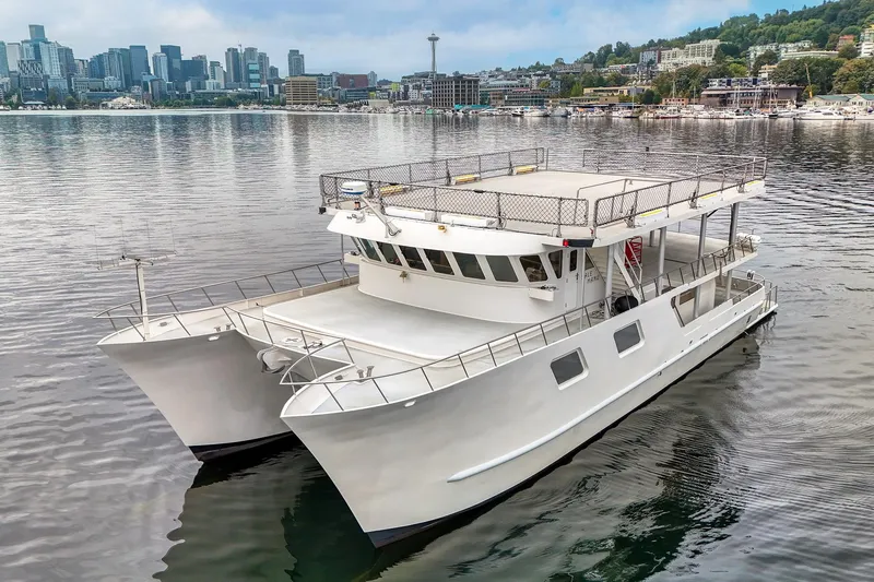 Slide: The Image of 2007 MetalCraft Catamaran on calm water with city skyline in background. - 6