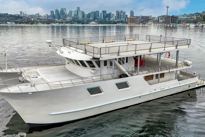 Slide: The Image of 2007 MetalCraft Catamaran docked with city skyline in the background. - 7