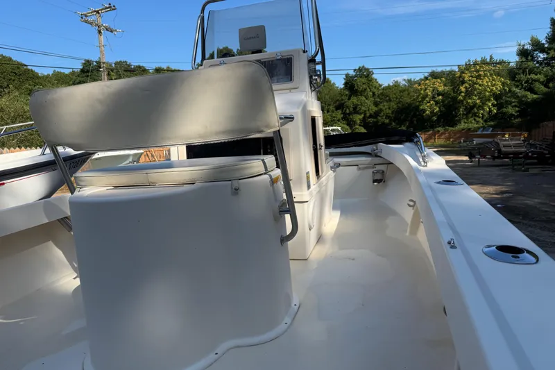 Slide: The Image of 2006 Parker 1801 Center Console boat with seating and control panel, outdoors. - 2