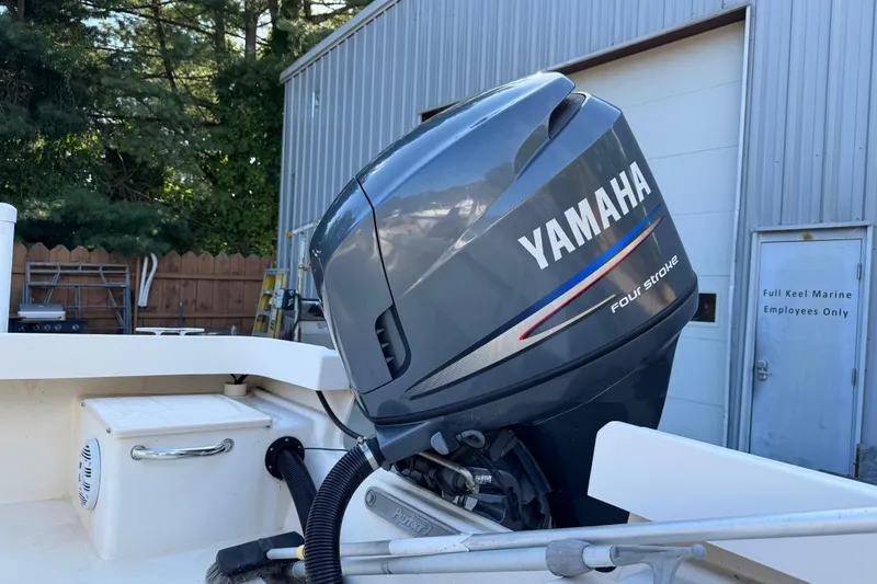 Slide: The Image of 2006 Parker 1801 Center Console with Yamaha four-stroke engine, docked near marine facility. - 4