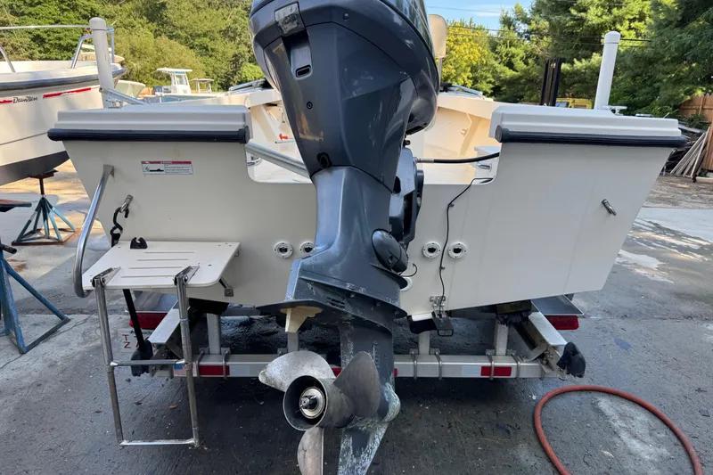 Slide: The Image of 2006 Parker 1801 Center Console boat with outboard motor on trailer. - 6