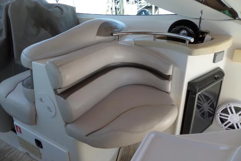 Slide: The Image of Luxury seating area on a 2003 Doral 280 SE boat, featuring beige leather upholstery. - 12