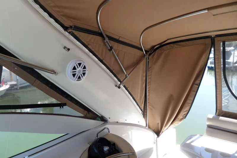 Slide: The Image of Interior view of a 2003 Doral 280 SE boat with tan canopy and speaker. - 14