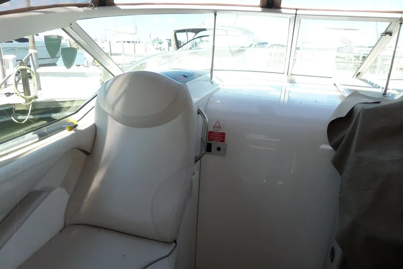 Slide: The Image of Interior view of 2003 Doral 280 SE boat with white seating and dashboard. - 17