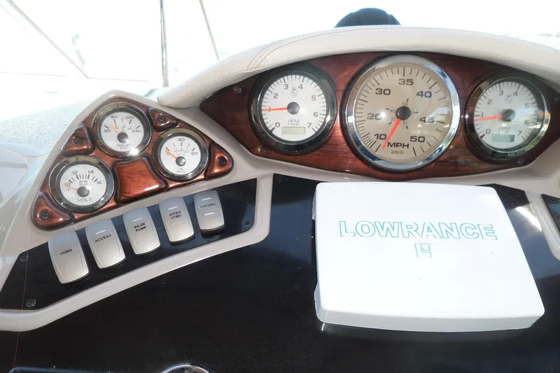Slide: The Image of Dashboard of 2003 Doral 280 SE boat with gauges and Lowrance device. - 18