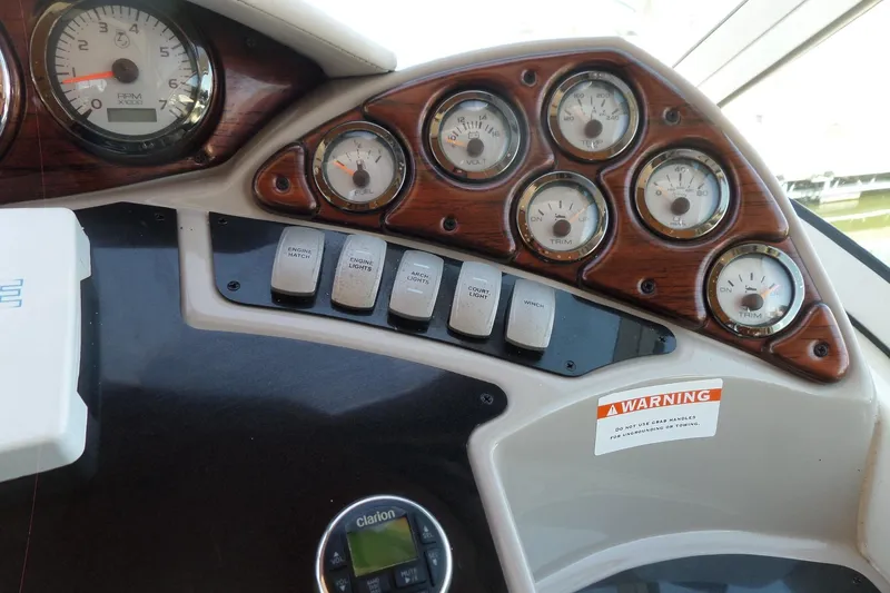 Slide: The Image of Dashboard of a 2003 Doral 280 SE boat with gauges and control switches. - 21