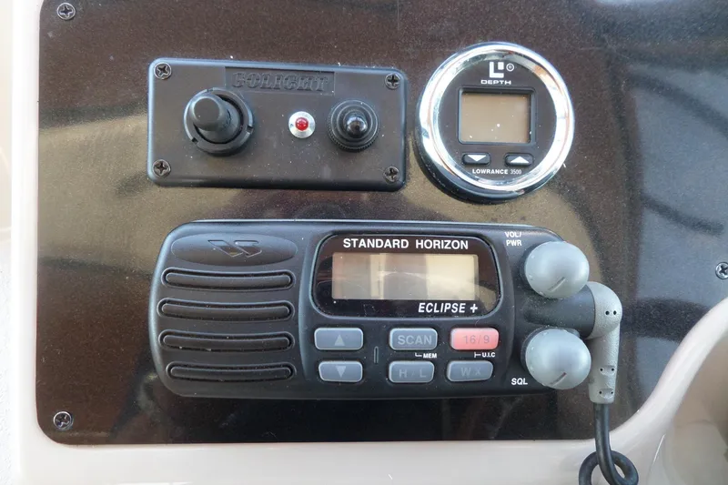 Slide: The Image of Control panel of a 2003 Doral 280 SE boat with radio and depth gauge. - 22