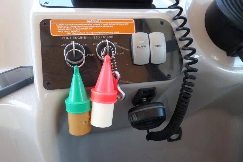 Slide: The Image of Control panel of a 2003 Doral 280 SE boat with ignition keys and switches. - 27