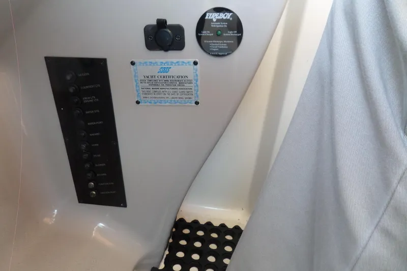 Slide: The Image of Control panel and yacht certification on 2003 Doral 280 SE boat interior. - 28