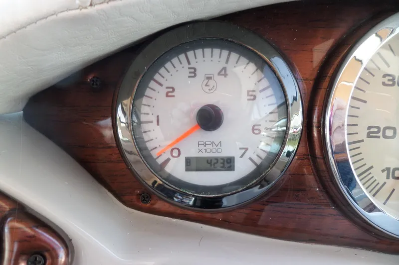 Slide: The Image of Tachometer of 2003 Doral 280 SE boat, showing 4239 RPM, with wood paneling. - 29