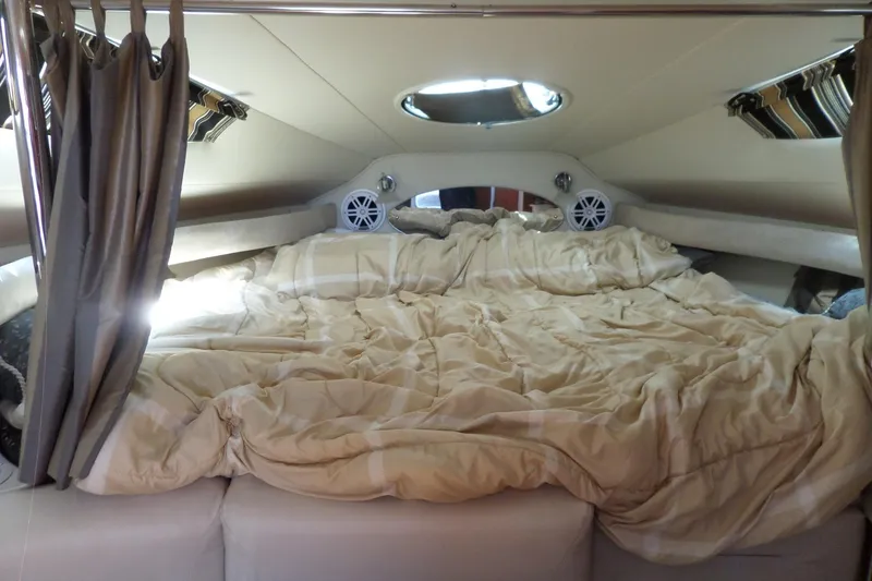 Slide: The Image of Cozy cabin interior of 2003 Doral 280 SE boat with bed and curtains. - 32