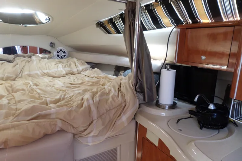 Slide: The Image of Interior of 2003 Doral 280 SE boat with cozy bed and kitchenette area. - 33