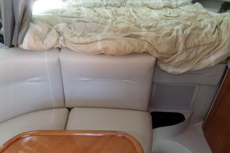 Slide: The Image of Interior of 2003 Doral 280 SE boat with beige seating and bedding. - 36