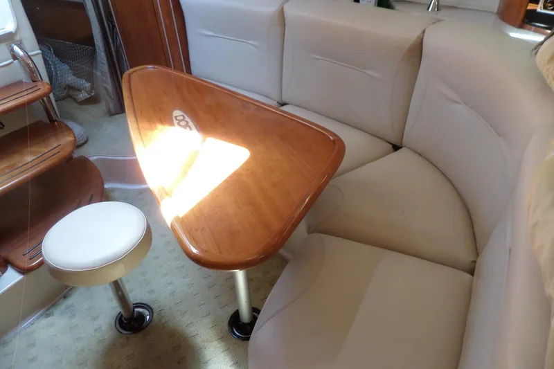 Slide: The Image of Interior of 2003 Doral 280 SE boat with beige seating and wooden table. - 39