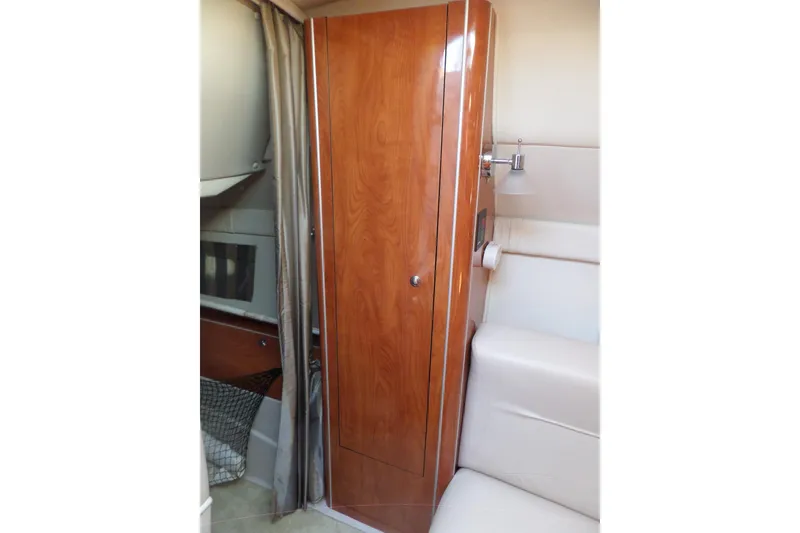 Slide: The Image of Interior of 2003 Doral 280 SE boat with wooden cabinet and seating area. - 43