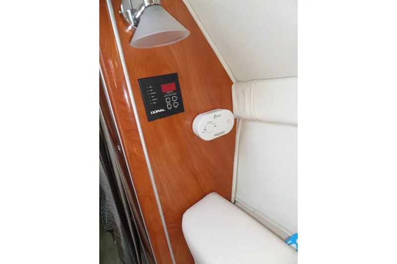 Slide: The Image of Interior of 2003 Doral 280 SE boat with control panel and smoke detector. - 44