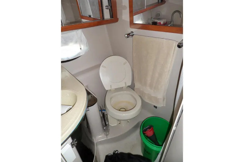 Slide: The Image of Compact bathroom in 2003 Doral 280 SE boat with toilet, sink, and towel. - 47