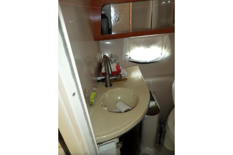 Slide: The Image of Compact bathroom sink area in a 2003 Doral 280 SE boat. - 48