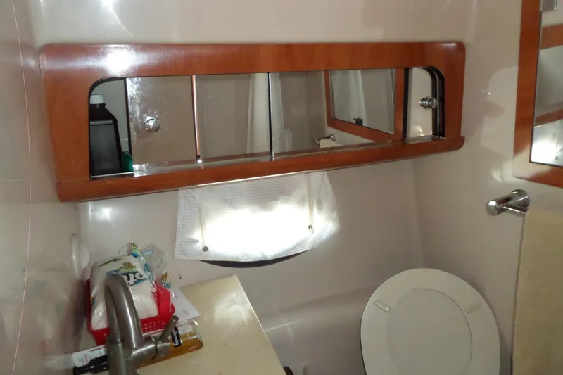 Slide: The Image of Bathroom interior of a 2003 Doral 280 SE boat with mirror and sink. - 49