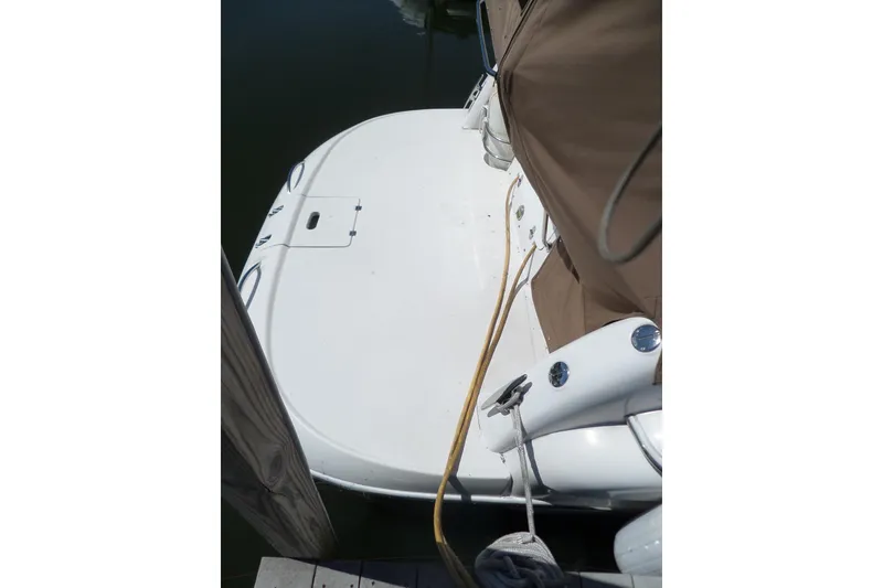 Slide: The Image of 2003 Doral 280 SE boat docked, showing rear deck and covered seating area. - 5