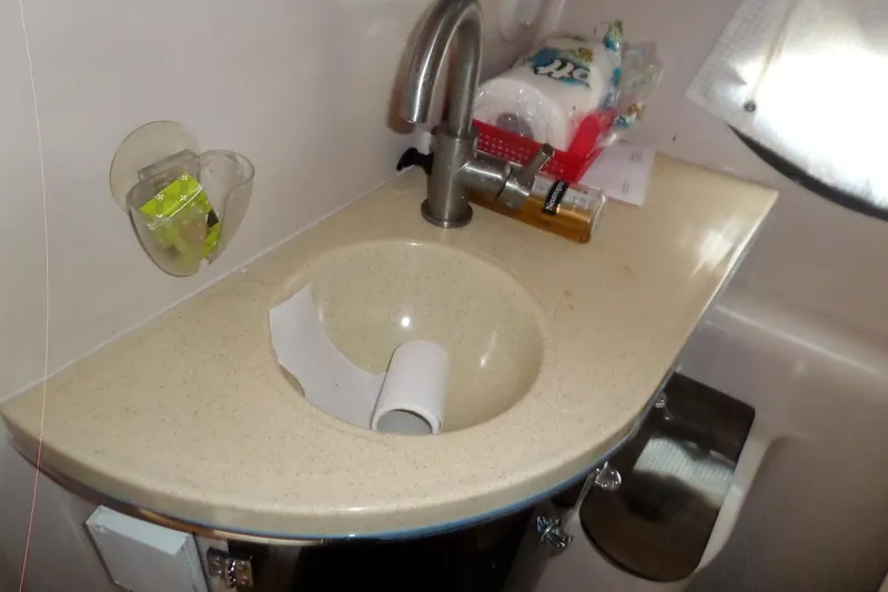 Slide: The Image of Compact bathroom sink in 2003 Doral 280 SE boat, featuring faucet and toiletries. - 50