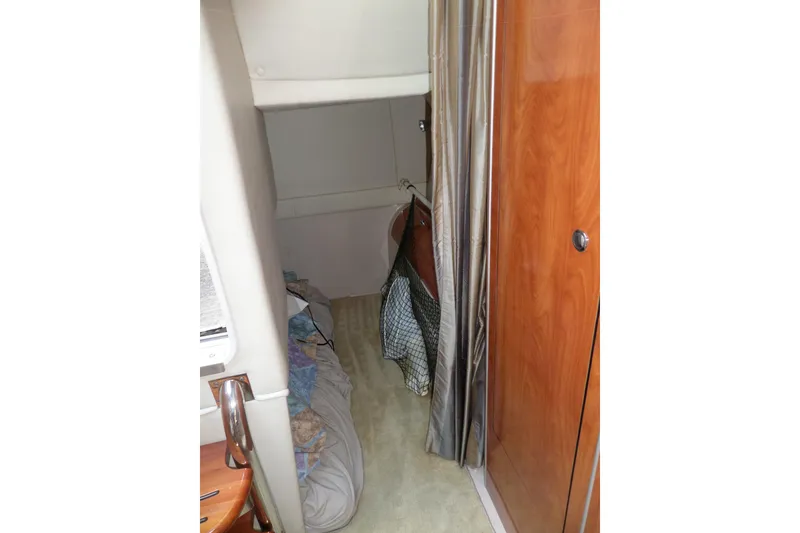 Slide: The Image of 2003 Doral 280 SE cabin interior with bed and wooden cabinetry. - 53