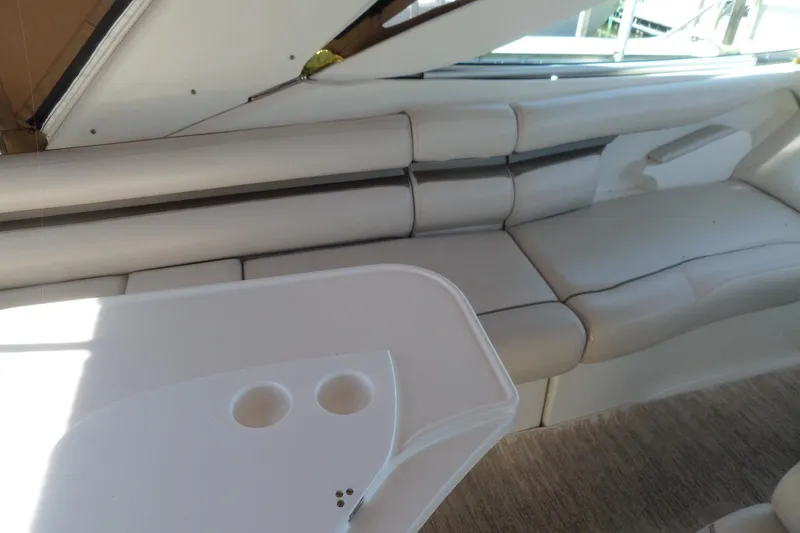 Slide: The Image of Interior of 2003 Doral 280 SE boat with white seating and table. - 8