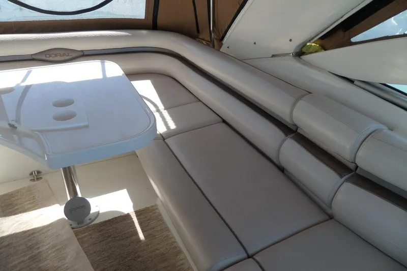 Slide: The Image of 2003 Doral 280 SE boat interior with white leather seating and table. - 9